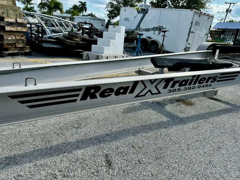 Slide: The Image of 2016 Real X Model R32X trailer frame in outdoor storage area. - 1