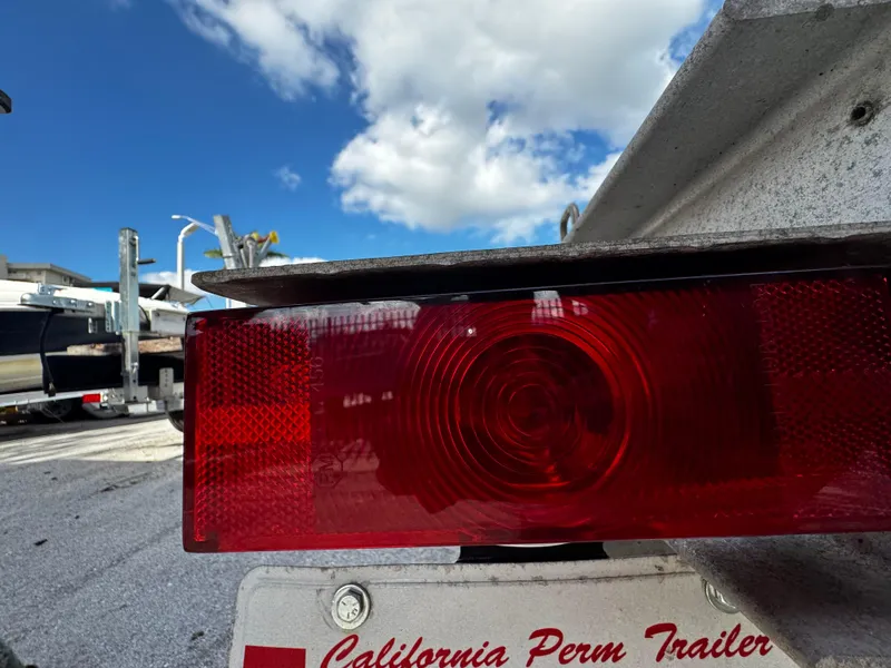 Slide: The Image of Close-up of a 2016 REAL X Model R32X trailer taillight under a blue sky. - 13