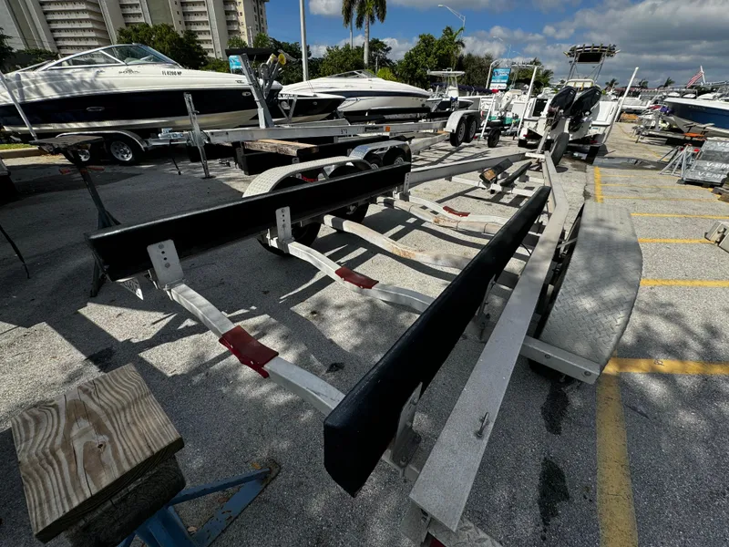 Slide: The Image of 2016 REAL X Model R32X trailer in a marina with boats. - 15