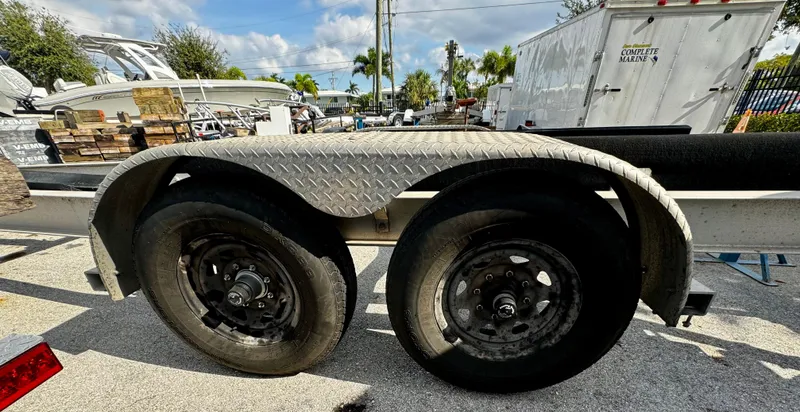 Slide: The Image of 2016 REAL X Model R32X trailer with dual wheels in a sunny outdoor setting. - 16