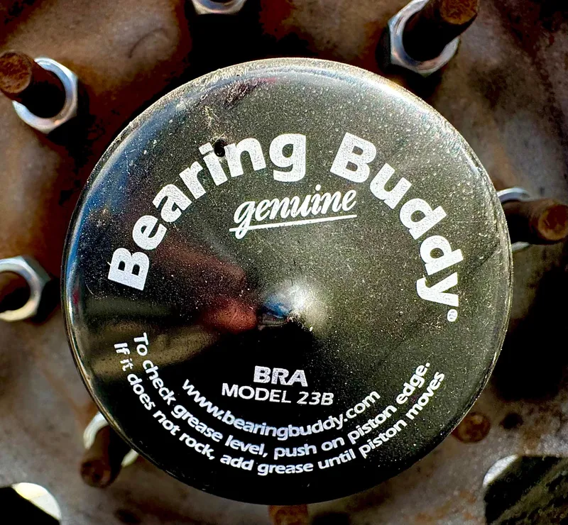 Slide: The Image of Close-up of Bearing Buddy cap on 2016 REAL X Model R32X trailer wheel. - 17
