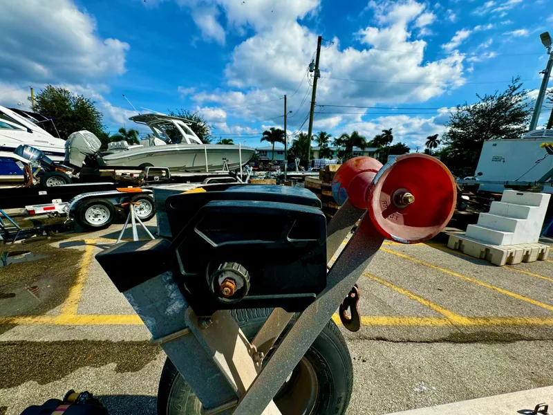 Slide: The Image of 2016 REAL X Model R32X trailer in a boatyard under a blue sky. - 22