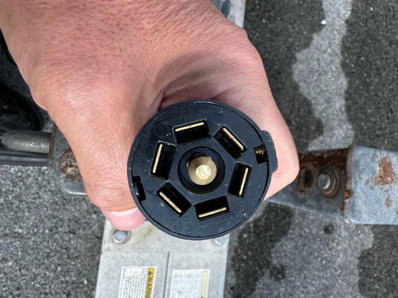 Slide: The Image of Close-up of a 2016 REAL X Model R32X trailer electrical connector plug. - 27
