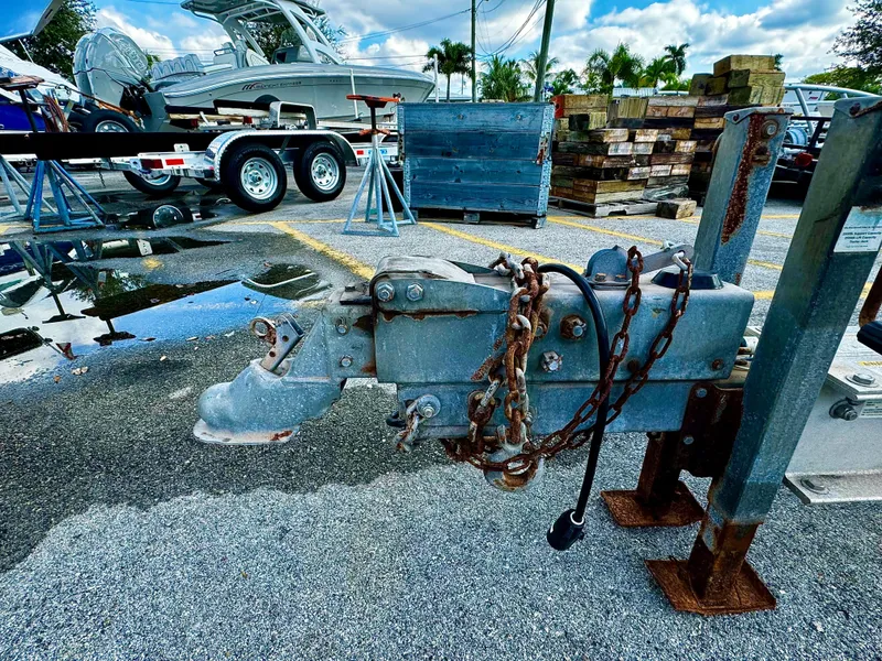 Slide: The Image of 2016 REAL X Model R32X trailer hitch with chains in a parking lot. - 28