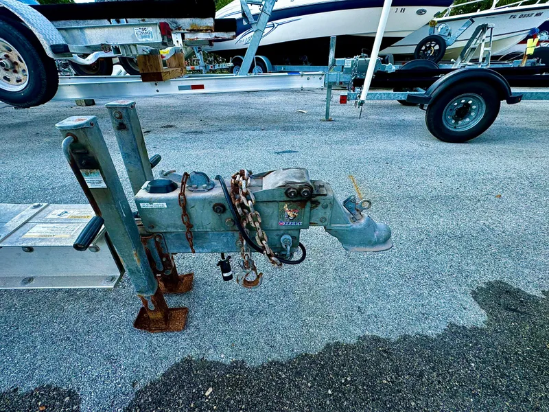 Slide: The Image of 2016 REAL X Model R32X trailer hitch with chains on asphalt. - 29