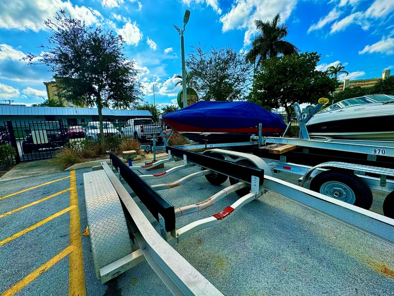 Slide: The Image of 2016 REAL X Model R32X trailer parked outdoors under a blue sky. - 3