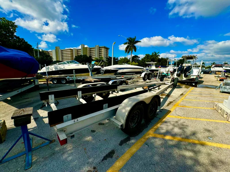 Slide: The Image of 2016 REAL X Model R32X trailer in a sunny marina parking lot. - 6