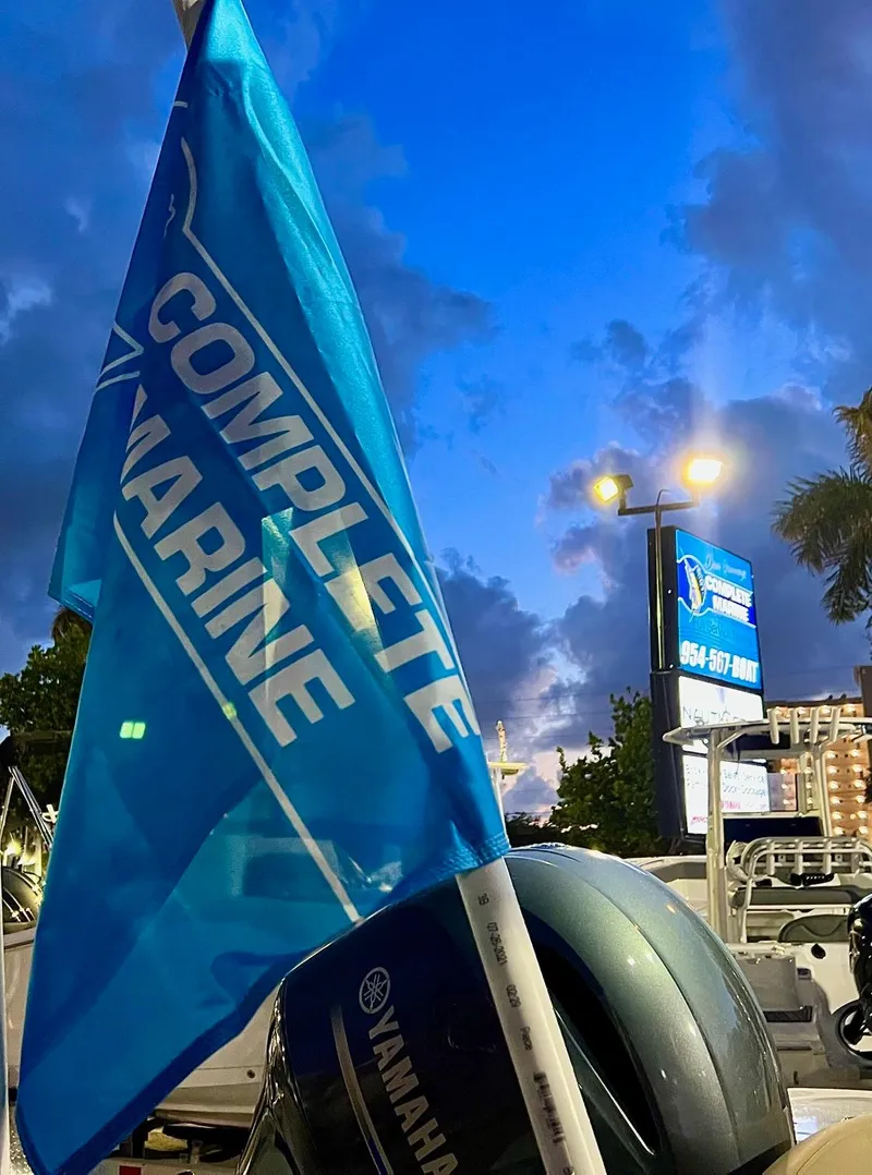 Slide: The Image of Blue "Complete Marine" flag with Yamaha motor, evening sky backdrop. - 8