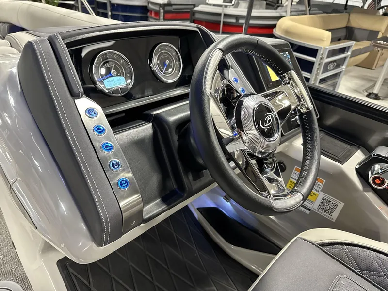 Slide: The Image of 2025 Barletta Lusso L25-UCA boat dashboard with steering wheel and control panel. - 10