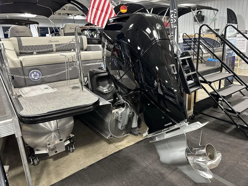 Slide: The Image of 2025 Barletta Lusso L25-UCA pontoon boat with powerful outboard motor in showroom. - 17