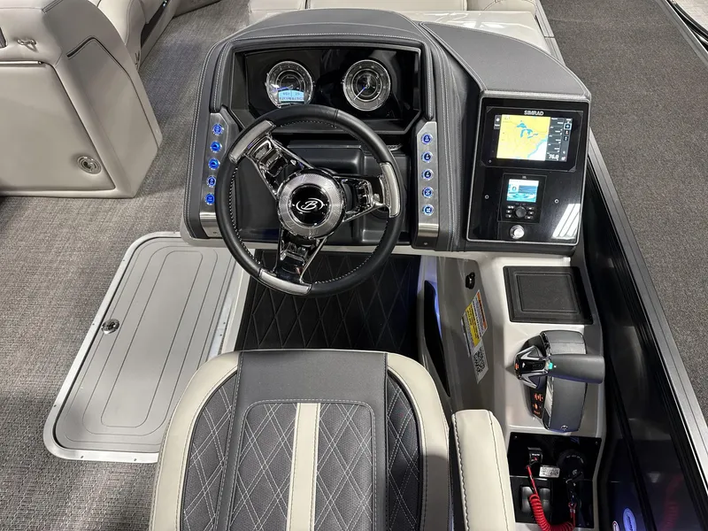 Slide: The Image of 2025 Barletta Lusso L25-UCA boat dashboard with steering wheel and navigation display. - 9