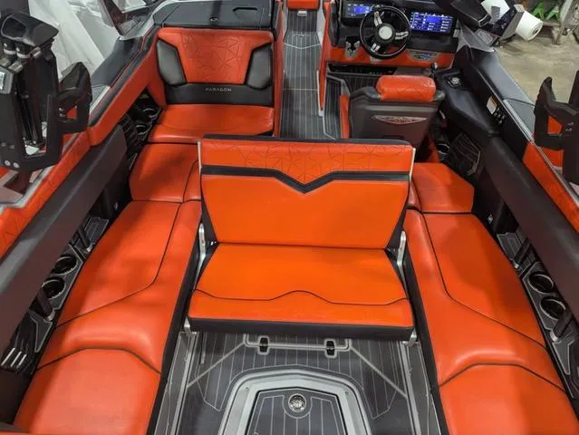 Slide: The Image of 2020 Nautique G23 Paragon interior with vibrant orange seating and modern dashboard. - 14
