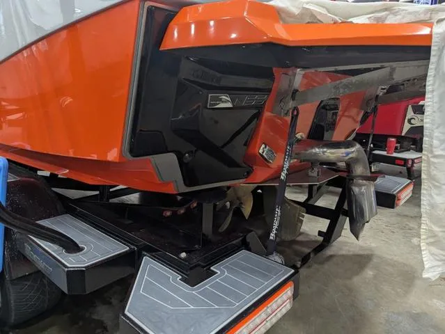 Slide: The Image of 2020 Nautique G23 Paragon boat, orange hull, detailed view of stern and propeller. - 21