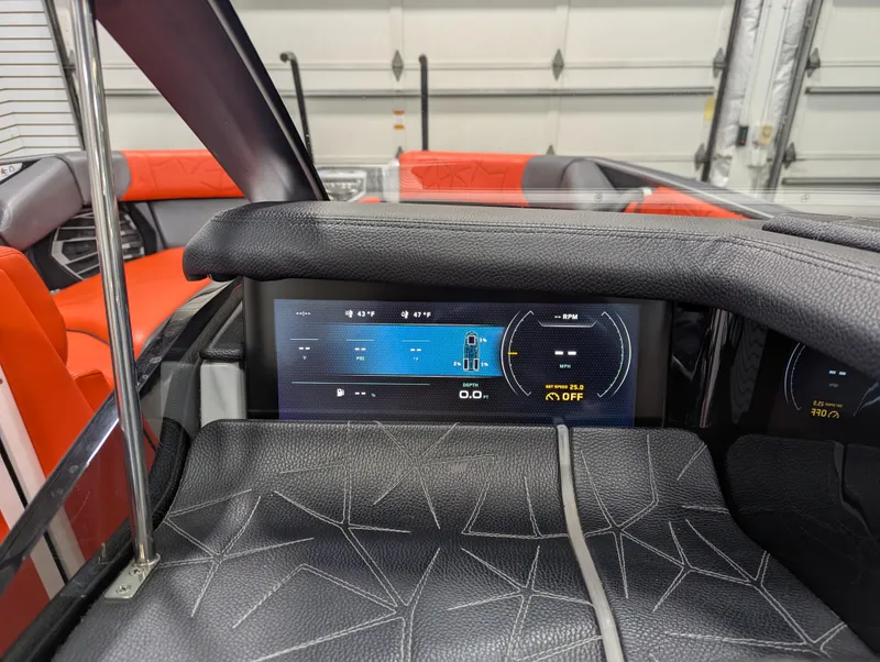 Slide: The Image of 2020 Nautique G23 Paragon dashboard with digital display and luxurious interior. - 30