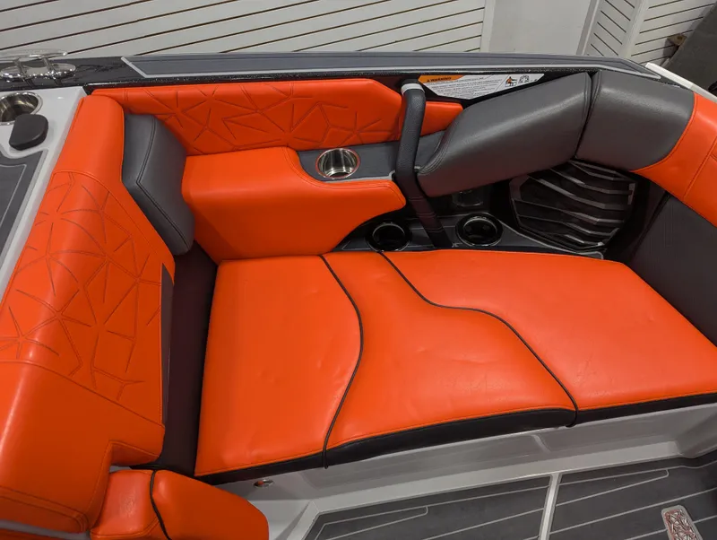 Slide: The Image of 2020 Nautique G23 Paragon interior with vibrant orange and black seating. - 31