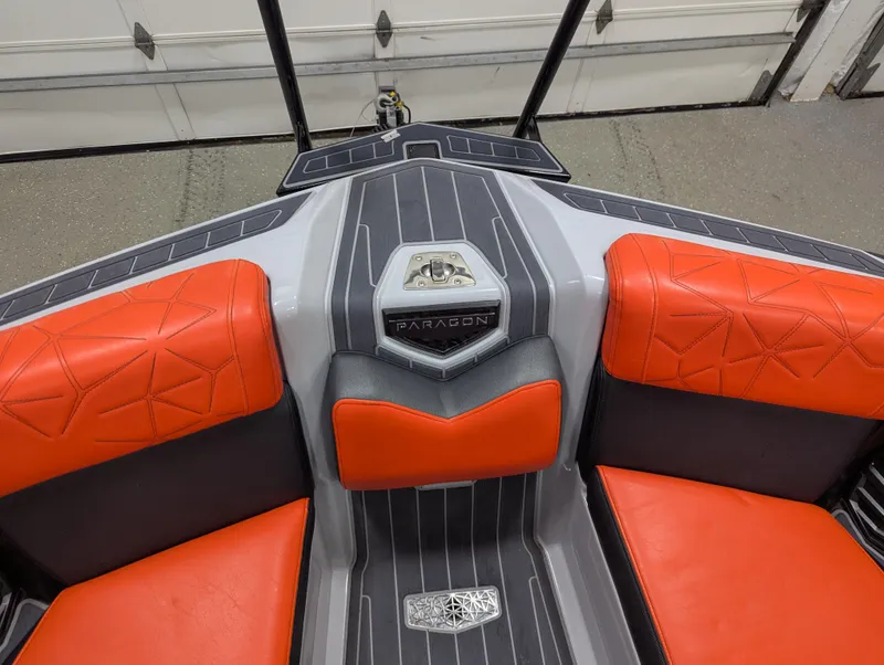 Slide: The Image of 2020 Nautique G23 Paragon boat interior with orange and gray seating. - 32