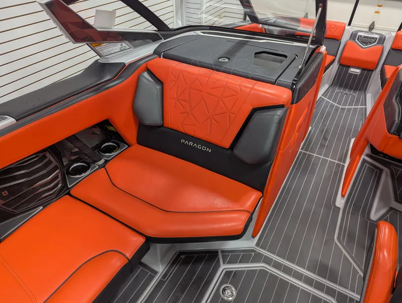 Slide: The Image of 2020 Nautique G23 Paragon interior with orange and black seating, modern design, and cup holders. - 33