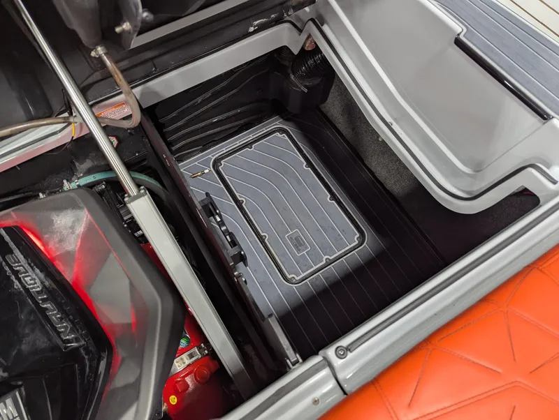 Slide: The Image of 2020 Nautique G23 Paragon storage compartment with detailed interior design. - 38