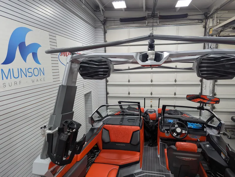 Slide: The Image of 2020 Nautique G23 Paragon boat interior with orange seating in a showroom. - 39