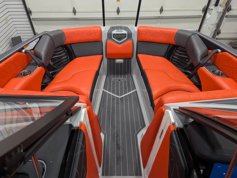 Slide: The Image of 2020 Nautique G23 Paragon boat interior with orange and gray seating. - 40