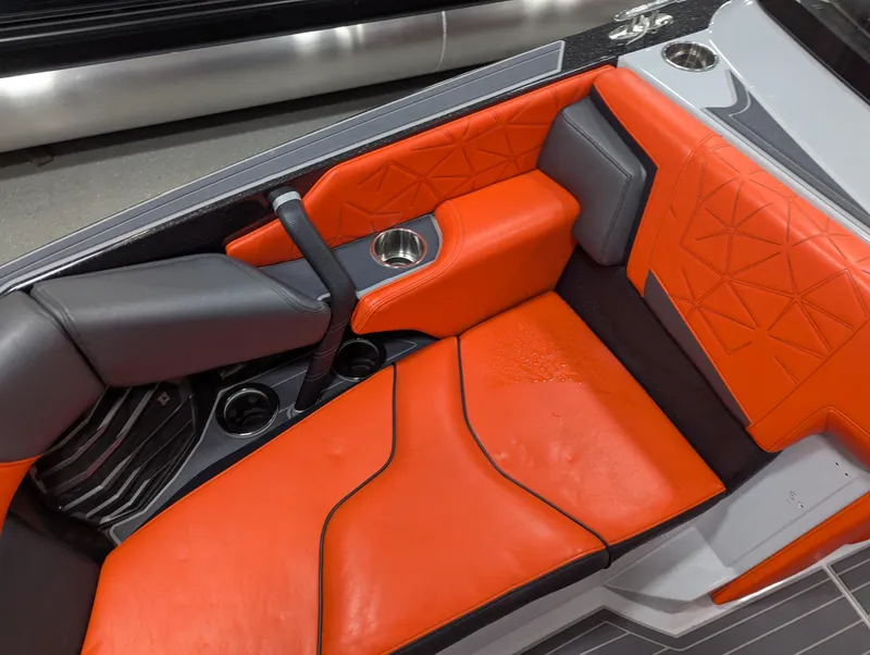 Slide: The Image of 2020 Nautique G23 Paragon interior with orange and gray seating, cup holders, and modern design. - 41