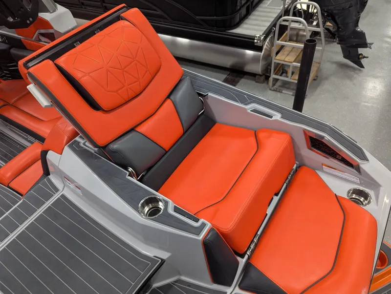 Slide: The Image of 2020 Nautique G23 Paragon interior with vibrant orange and gray seating. - 45