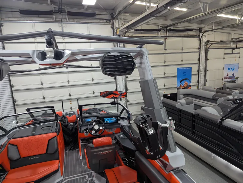 Slide: The Image of 2020 Nautique G23 Paragon boat interior with red and black seating in a showroom. - 46