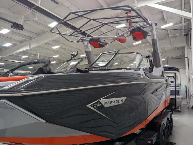 Slide: The Image of 2020 Nautique G23 Paragon boat in showroom, featuring sleek design and modern wakeboard tower. - 5
