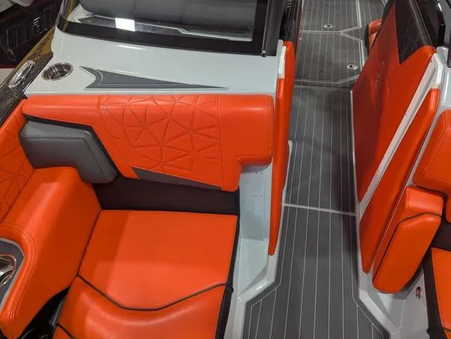 Slide: The Image of 2020 Nautique G23 Paragon interior with vibrant orange seating and sleek design. - 7