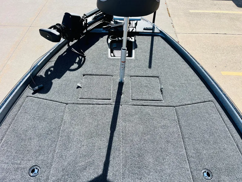 Slide: The Image of 2025 Nitro Z21 XL Pro boat deck with carpeted surface and storage compartments. - 14