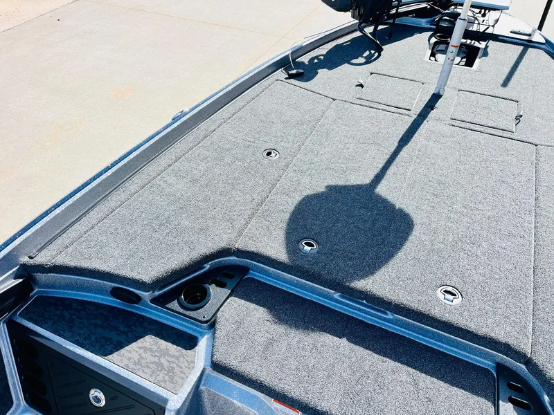 Slide: The Image of 2025 Nitro Z21 XL Pro boat deck with carpeted surface and storage compartments. - 18
