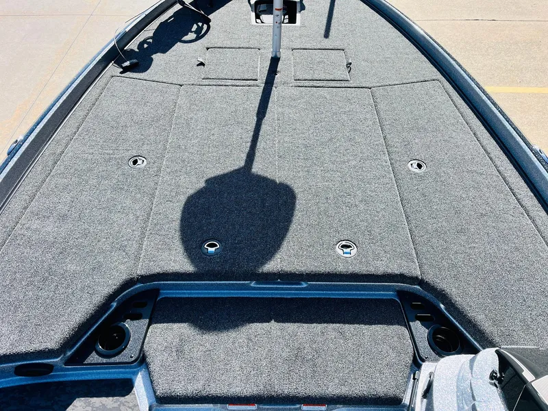 Slide: The Image of 2025 Nitro Z21 XL Pro boat deck with carpeted surface and storage compartments. - 21