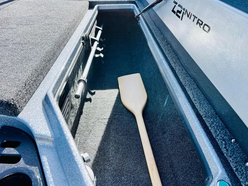 Slide: The Image of 2025 Nitro Z21 XL Pro boat storage compartment with paddle. - 30