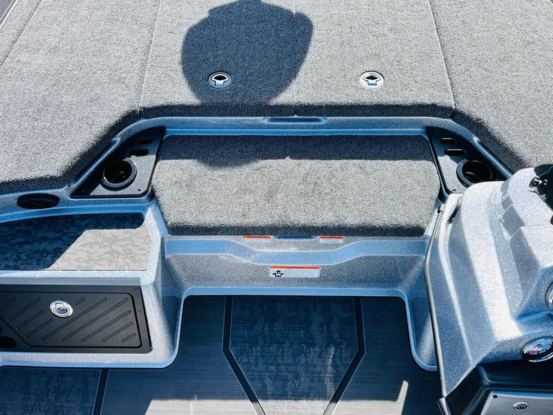 Slide: The Image of 2025 Nitro Z21 XL Pro boat interior with storage compartments and carpeted deck. - 31