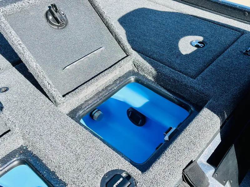 Slide: The Image of 2025 Nitro Z21 XL Pro boat storage compartments with blue interior. - 47