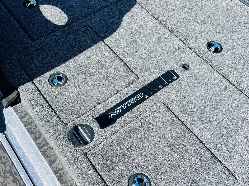 Slide: The Image of 2025 Nitro Z21 XL Pro boat deck with storage compartments and logo. - 48