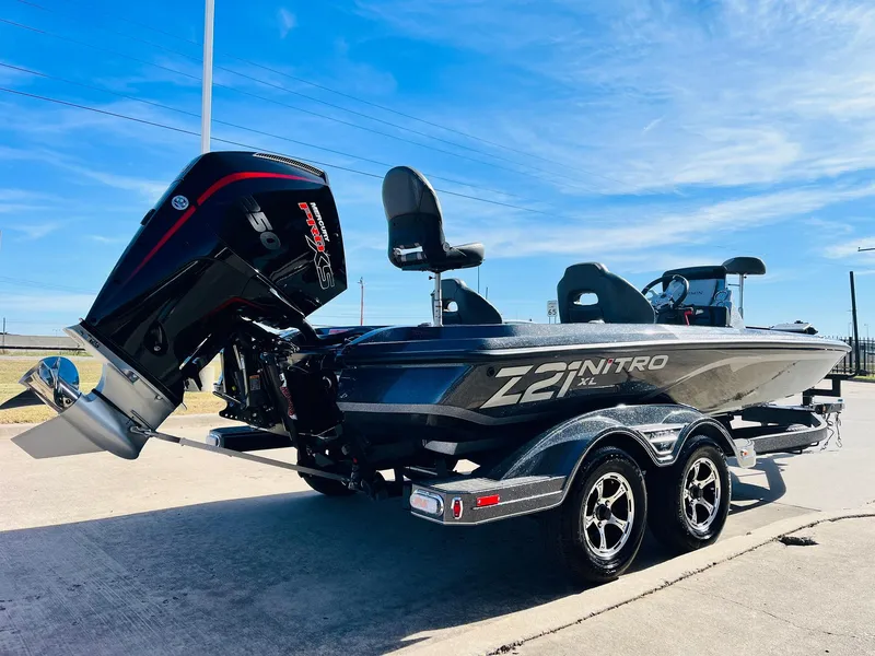 Slide: The Image of 2025 Nitro Z21 XL Pro boat with powerful outboard motor on a sunny day. - 5