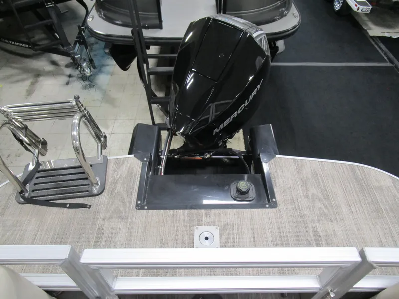 Slide: The Image of 2024 Ranger Reata 243C boat with Mercury outboard motor, rear deck view. - 16