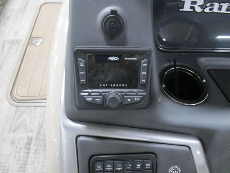 Slide: The Image of 2024 Ranger Reata 243C dashboard with audio controls and cup holder. - 17