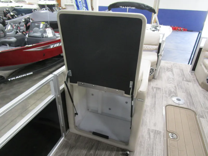 Slide: The Image of 2024 Ranger Reata 243C boat interior storage compartment with open lid, showcasing spacious design. - 19