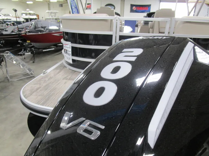 Slide: The Image of 2024 Ranger Reata 243C boat with Mercury 200 V6 engine in showroom. - 21