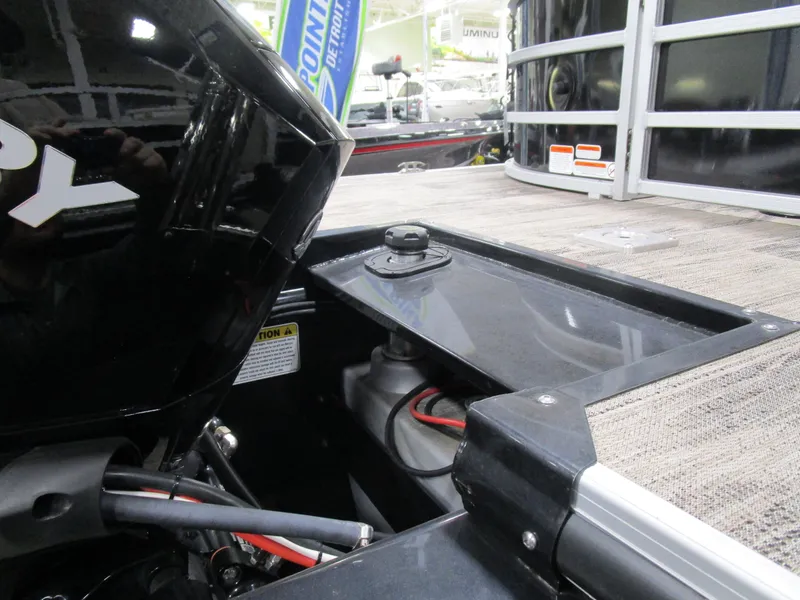 Slide: The Image of 2024 Ranger Reata 243C boat engine compartment with visible wiring and components. - 23