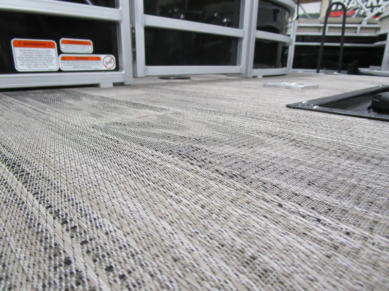 Slide: The Image of 2024 Ranger Reata 243C deck with textured flooring and safety labels. - 5