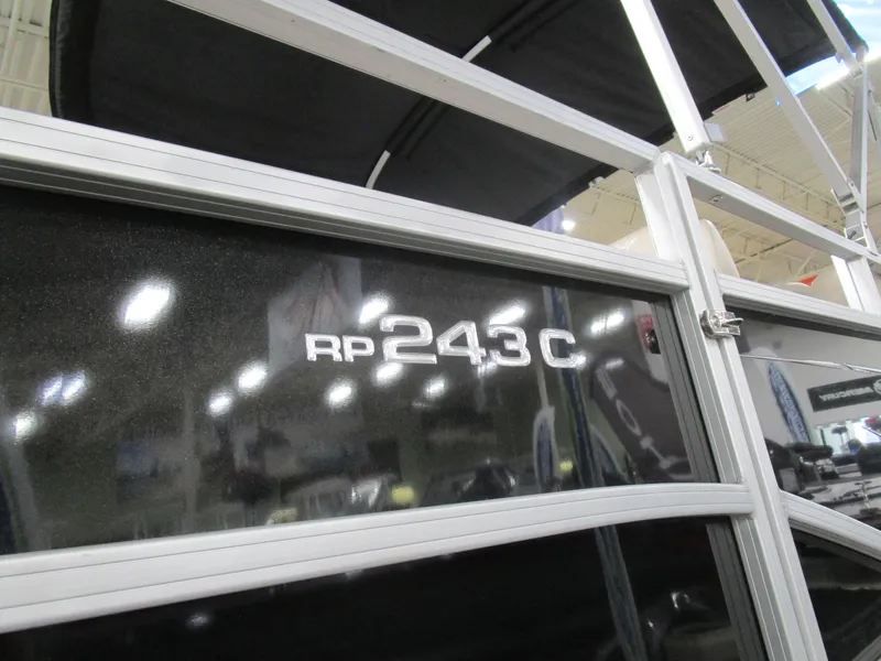 Slide: The Image of 2024 Ranger Reata 243C boat model detail with reflective surface and structural frame. - 6