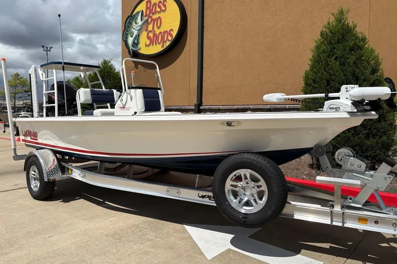 Slide: The Image of 2025 Mako 18 Pro Skiff Patriot Edition boat on trailer at Bass Pro Shops. - 1