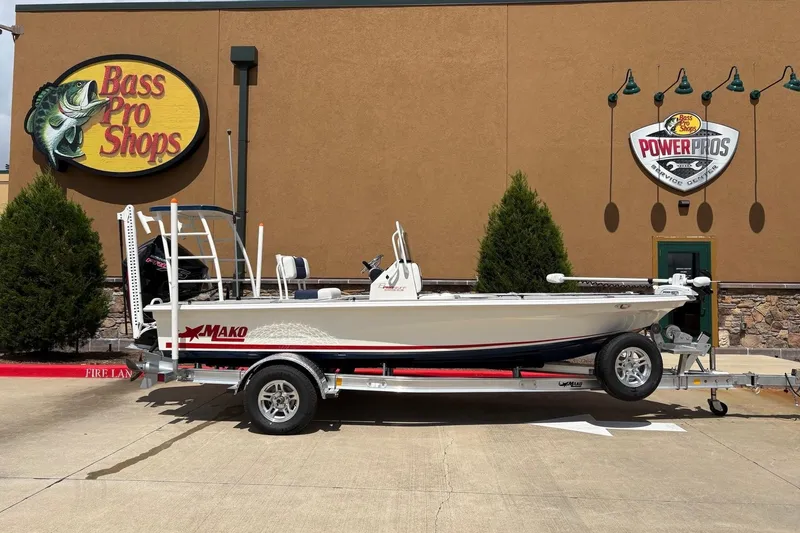 Slide: The Image of 2025 Mako 18 Pro Skiff Patriot Edition boat on trailer at Bass Pro Shops. - 2
