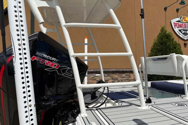 Slide: The Image of 2025 Mako 18 Pro Skiff Patriot Edition with Mercury Pro XS engine, docked outdoors. - 8