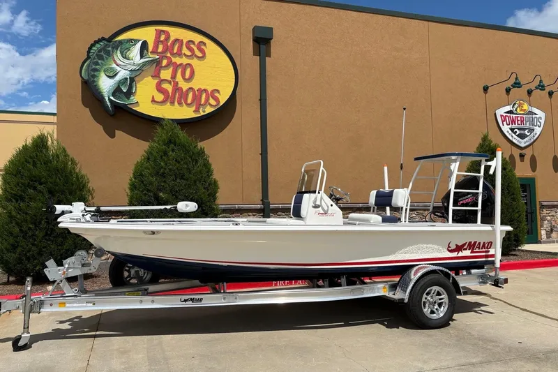 Slide: The Image of 2025 Mako 18 Pro Skiff Patriot Edition boat at Bass Pro Shops entrance. - 3