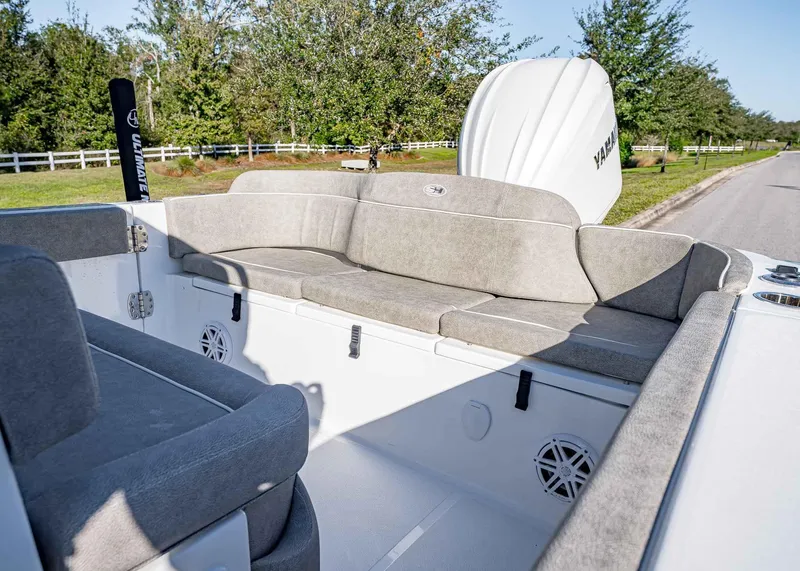 Slide: The Image of 2025 Sea Hunt Ultra 239 SE boat interior with cushioned seating and Yamaha engine. - 10