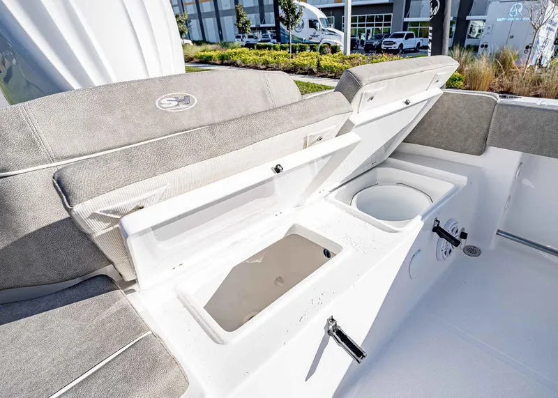Slide: The Image of 2025 Sea Hunt Ultra 239 SE boat interior with open storage compartments. - 12